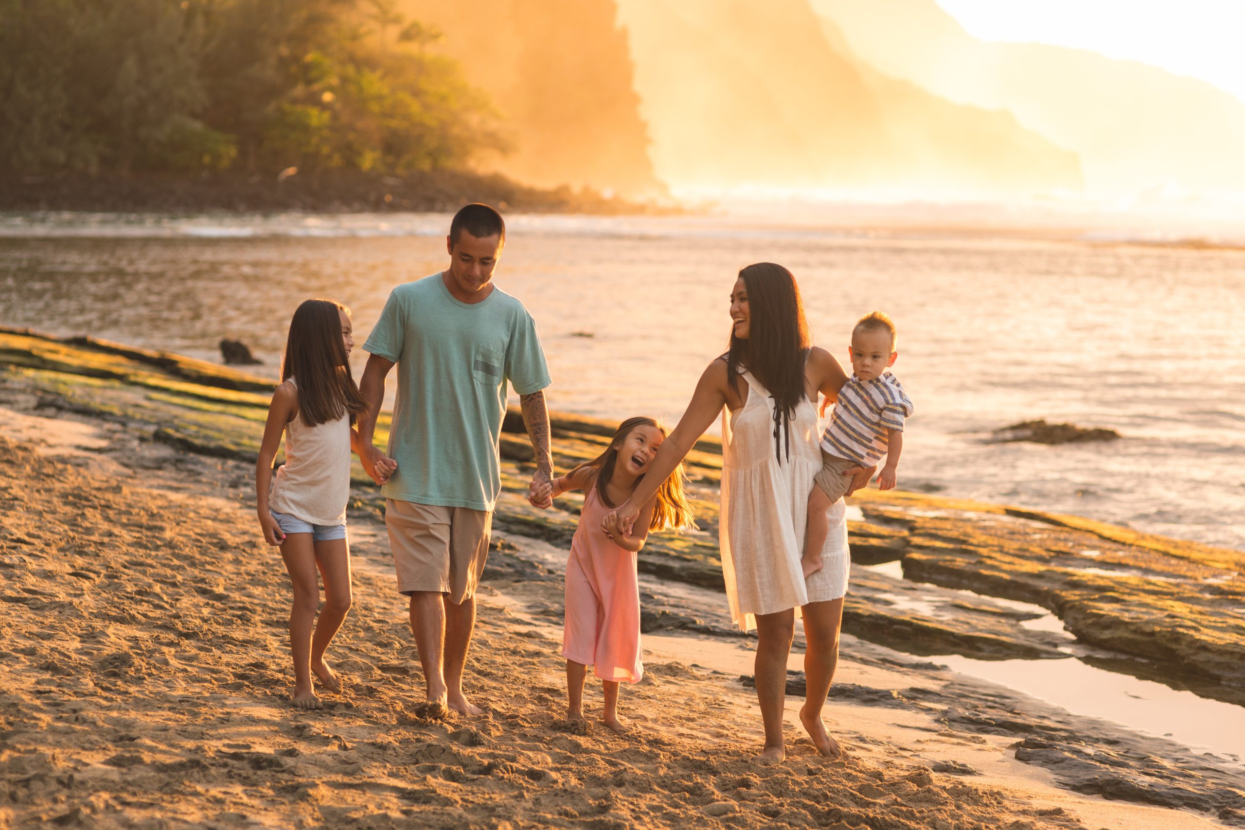 Hawaii family vacation on beach Family walking together on beautiful Hawaii beach